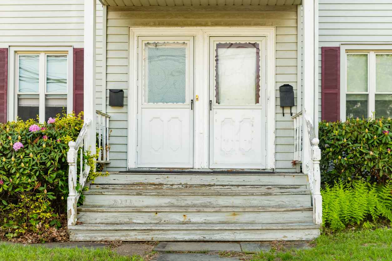This is a photograph of two doors at the front entrance to separate residences in one house in Ramsey, New Jersey, USA